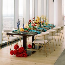 champagne-venus-chairs-with-bud-vases-and-bright-florals